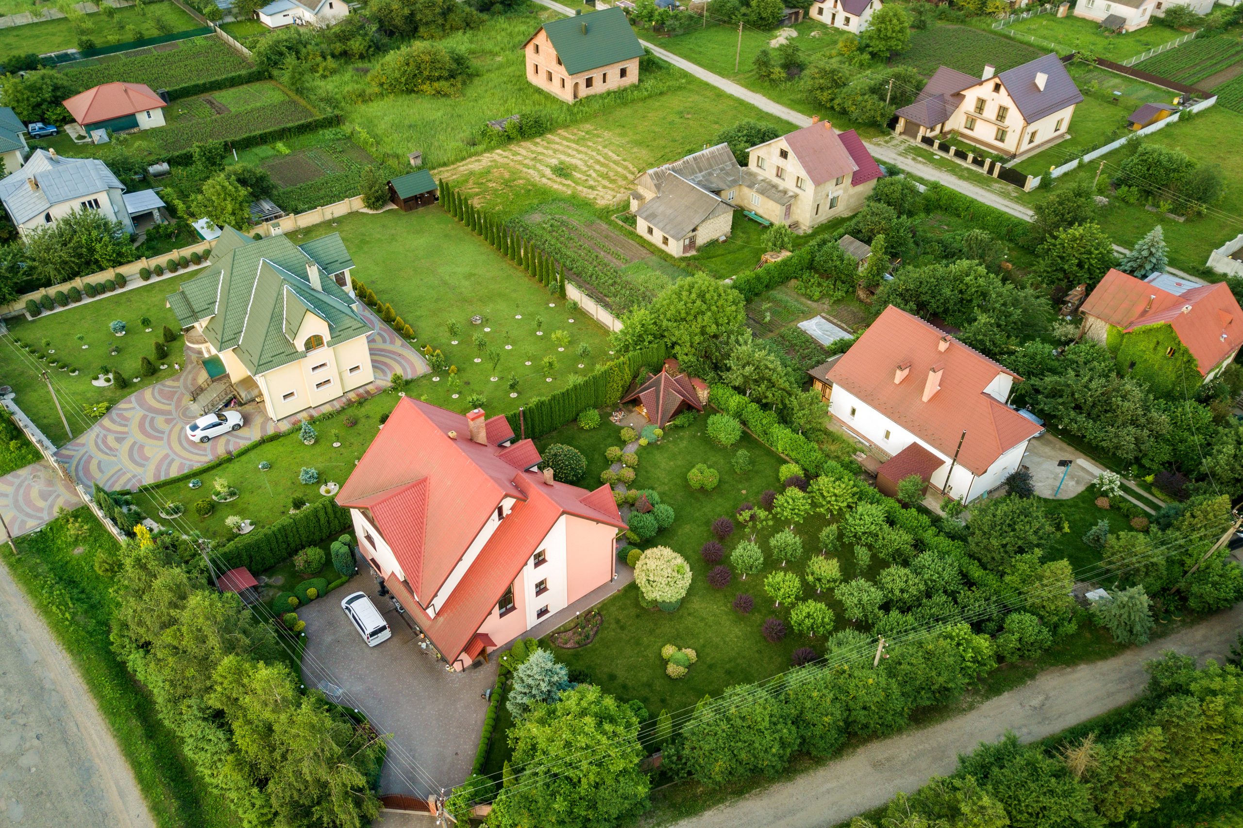 Aerial landscape of small town or village with rows of residential homes and green trees