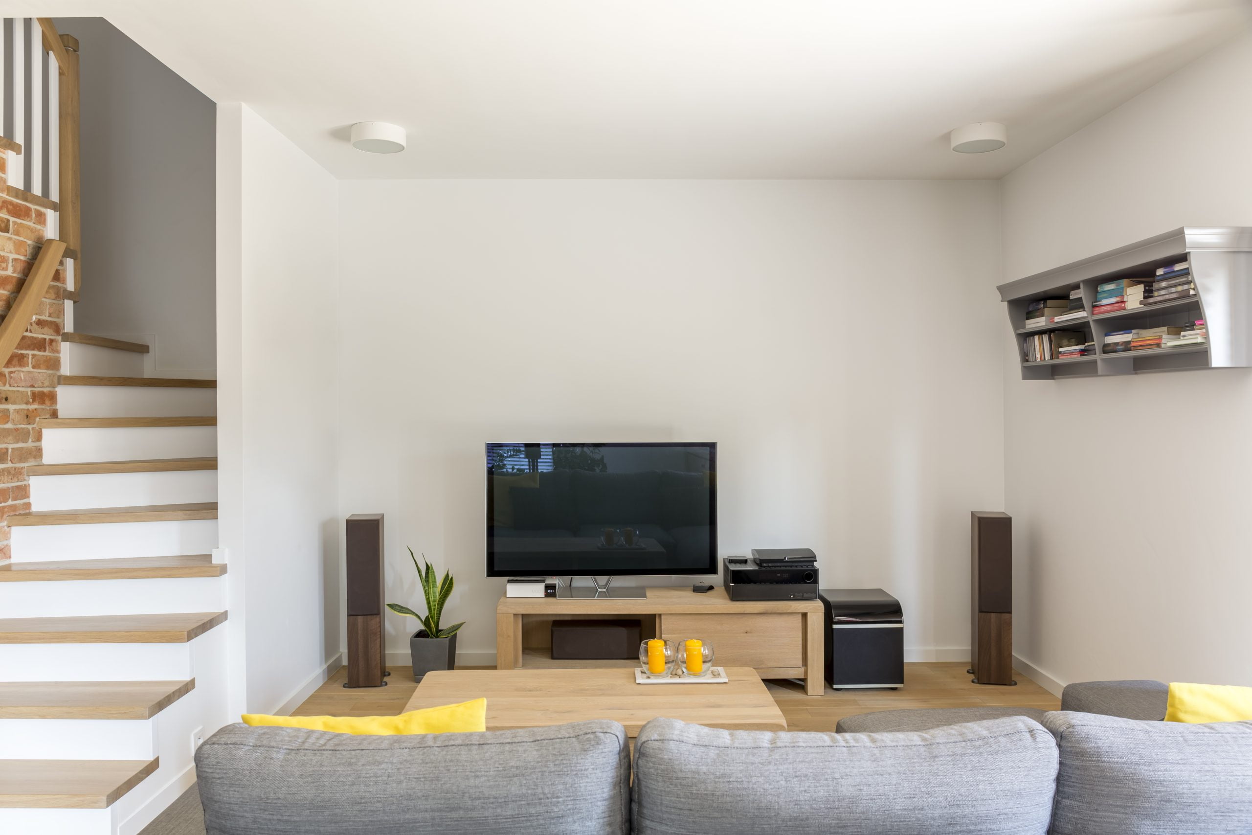 Open living room with tv, sofa and staircase