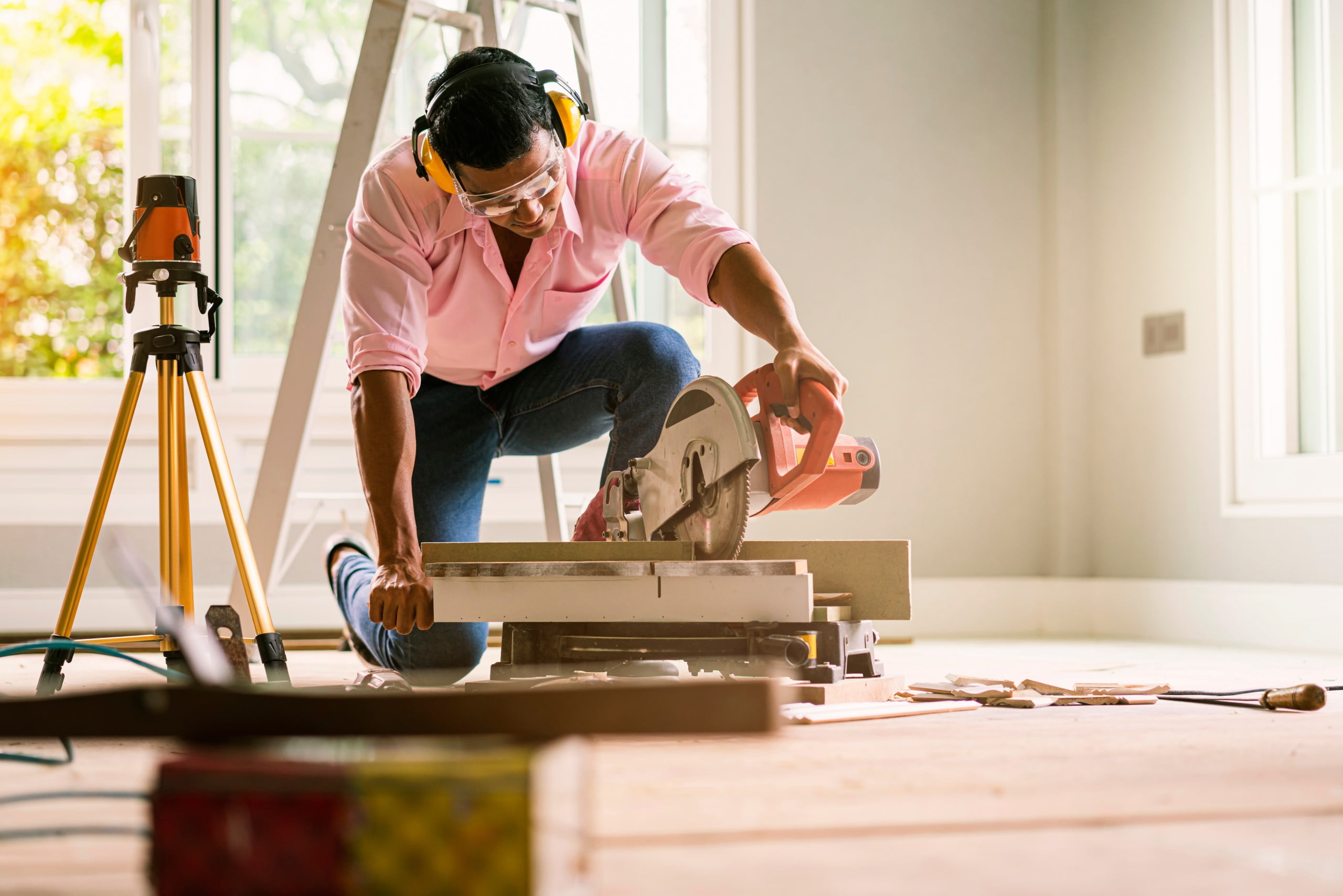 Contractor using hand saw for home improvement project